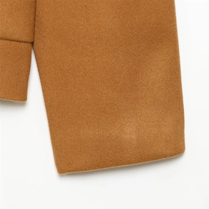 Detailed close-up of camel wool coat cuffs featuring premium textured fabric and neat stitching