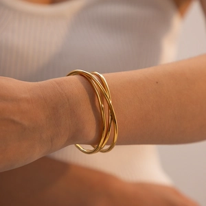 Elegant 18k gold-plated triple-ring stainless steel bangle on female wrist
