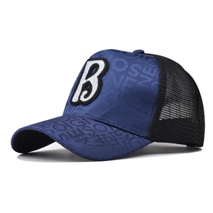 Detail of embroidered B letter on navy canvas baseball cap with mesh back ventilation
