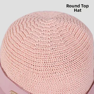 Detail of pink knitted sun hat showing intricate crochet texture and matching ribbon trim