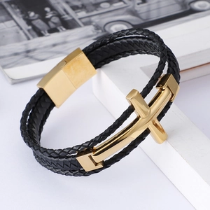 Detail of black multi-layer braided leather bracelet with golden steel cross and magnetic clasp