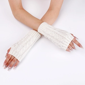 Close-up of cable knit fingerless gloves in cream white with soft wool texture details