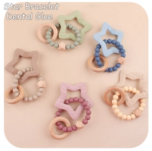 Five assorted silicone star teethers with wooden rings and beads in pastel colors
