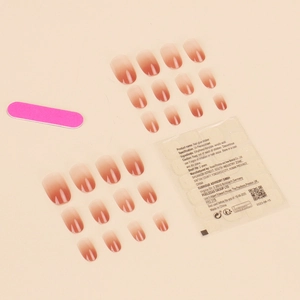 Short press-on nail kit with nude pink gradient tips, including glue stickers and file