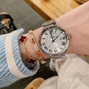 Elegant silver stainless steel watch with white roman numeral dial on woman's wrist