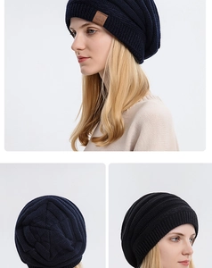 Detail showing the thick knit texture and brown leather 'Sport' patch on winter beanies