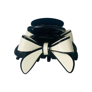 Elegant black and white bow hair claw clip made of glossy acetate with a strong grip