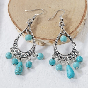 Detail view of Bohemian silver earrings with turquoise beads and teardrop pendant