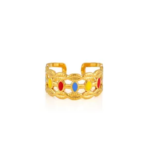 Detail of adjustable gold ring with wave texture and tri-color enamel inlays