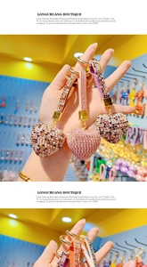 Close-up of pink, brown and colorful heart keychains with rhinestones and gold hardware