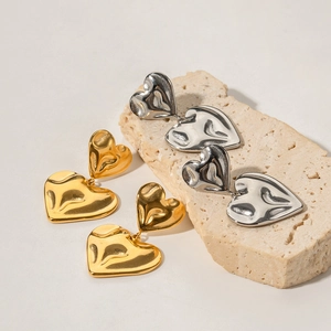 Double heart drop earrings with hammered texture in gold and silver stainless steel