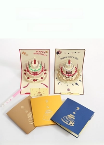 Detail of 3D pop-up birthday cake cards in multiple colors with laser-cut paper art