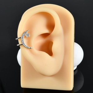 Star and moon ear cuff in silver finish with sparkling cubic zirconia on silicone ear