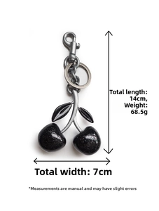 Detail of 14cm cherry charm keychain with gunmetal chain and black glitter cherries