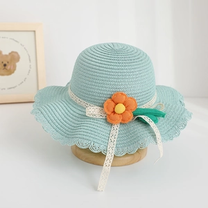 Cute mint green straw sun hat for kids featuring an orange flower and lace detail
