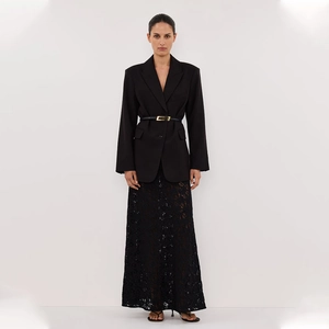 Close-up of black lace maxi skirt with slim gold buckle belt and oversized blazer