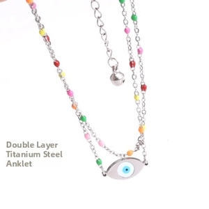 Detail of double-layer titanium steel anklet with colorful beads and evil eye charm