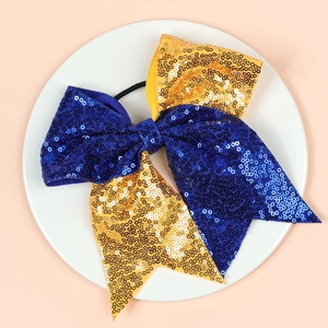 Nœud élastique à paillettes bleu et or pour filles sur une assiette blanche propre