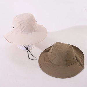 Detail of kids sun hats in beige and olive with wide brim and adjustable chin straps