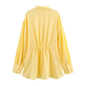 Rear view of yellow long-sleeved shirt with waist drawstring and white button cuffs