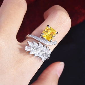 Macro shot of Radiant-cut yellow gemstone ring with leaf-shaped marquise side diamonds