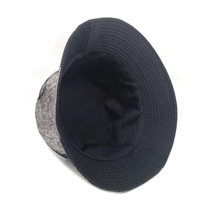 Detail view of double-sided reversible bucket hat with grey marble texture and black lining