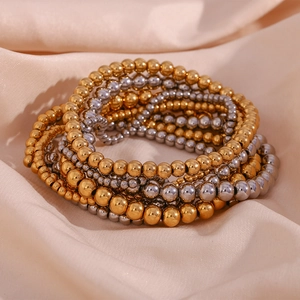 Retro 18K gold and silver plated stainless steel elastic bead bracelets on champagne silk