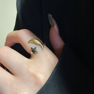 Detailed view of bicolor celestial open ring featuring golden moon and silver star design