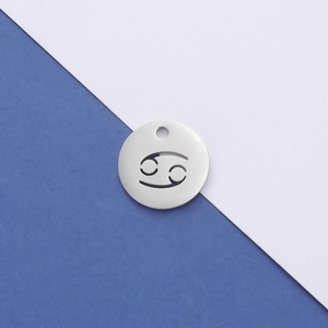 Close-up of a silver mirror-finish stainless steel Cancer constellation pendant with cutout