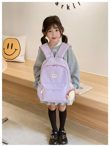 Detail view of purple kids backpack with cute cat patch and plush toast pendant charm