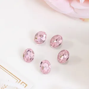 Macro view of 8x10mm pink oval rhinestones with faceted cut on a decorative card