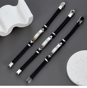 Detail of multi-layer braided leather bracelets with gold and silver stainless steel ID plates