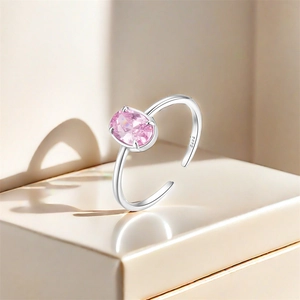 Macro detail of S925 sterling silver stamp and pink oval zircon in four-prong setting