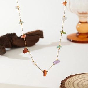 Close-up of stainless steel necklace with colorful irregular stones and pearls