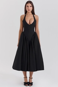 Detailed view of deep V-neckline and pleated waist on black halter backless maxi dress