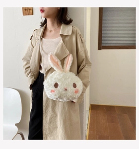 Detailed view of a plush white bunny crossbody bag with an elegant pearl strap
