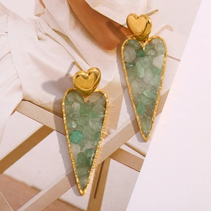 Detailed close-up of 18K gold heart earrings with embedded green crushed stones