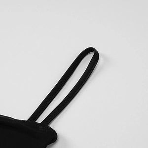 Detailed close-up of spaghetti straps and fine mesh fabric on a black summer dress