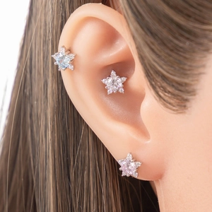 Star-shaped silver cartilage earrings with clear and blue heart-and-arrow cubic zirconia