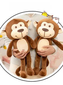 Close-up of soft plush monkey toys with long arms and tails in a home setting
