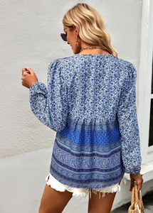 Detail of bohemian floral blouse back featuring contrast print hem and elegant long sleeves