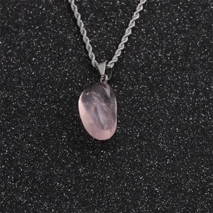 Minimalist silver necklace featuring an irregular pink crystal pendant on a braided chain