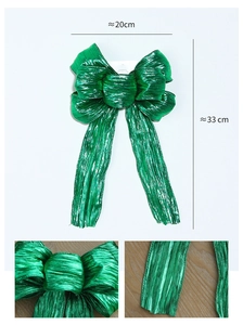 Detailed dimensions and texture of large metallic green Christmas glitter ribbon bow