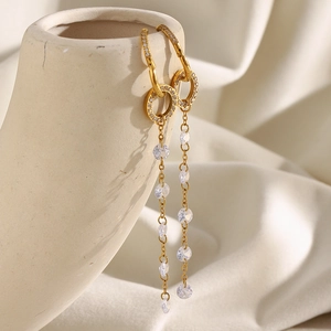 Elegant 18K gold plated stainless steel hoop earrings with long zircon tassels on ceramic