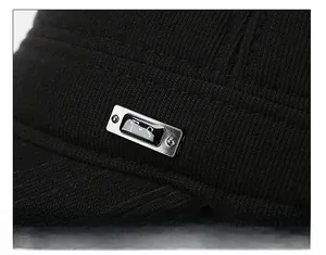 Macro shot of vertical rib texture and silver F-S metal logo on black winter hat