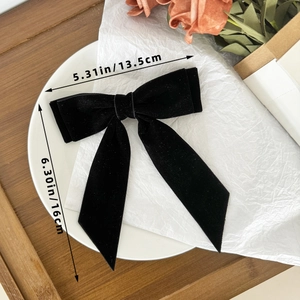 Detail of elegant black velvet bow hair clip with ribbons and size measurements