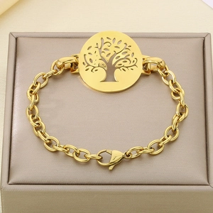 18K gold plated stainless steel bracelet with hollow tree of life charm on jewelry stand