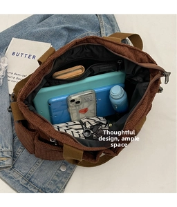 Detailed internal view of brown corduroy tote bag showing spacious capacity and pockets