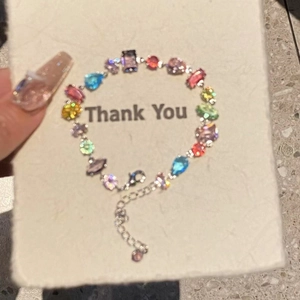 Detail of colorful gemstone bracelet with silver chain extension and lobster clasp