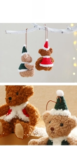 Close-up of Christmas plush bear ornaments with soft textures and festive red and green vests